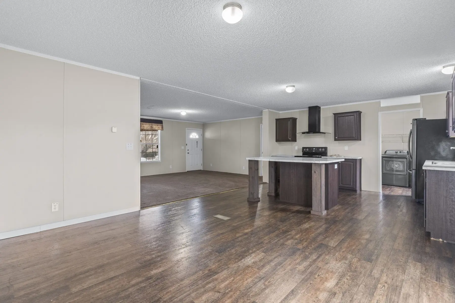 Wide view across the living area toward the kitchen