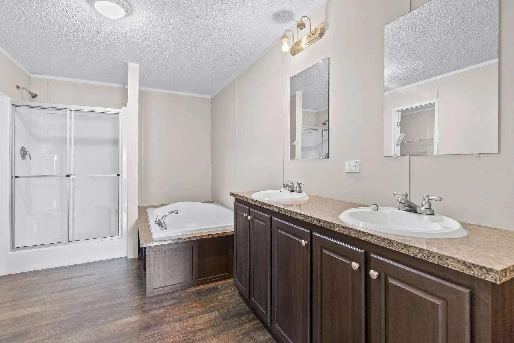 Primary bathroom with double-sink vanity, garden tub and separate shower
