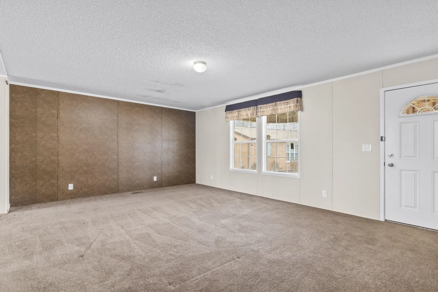 Carpeted bedroom with window and doorway