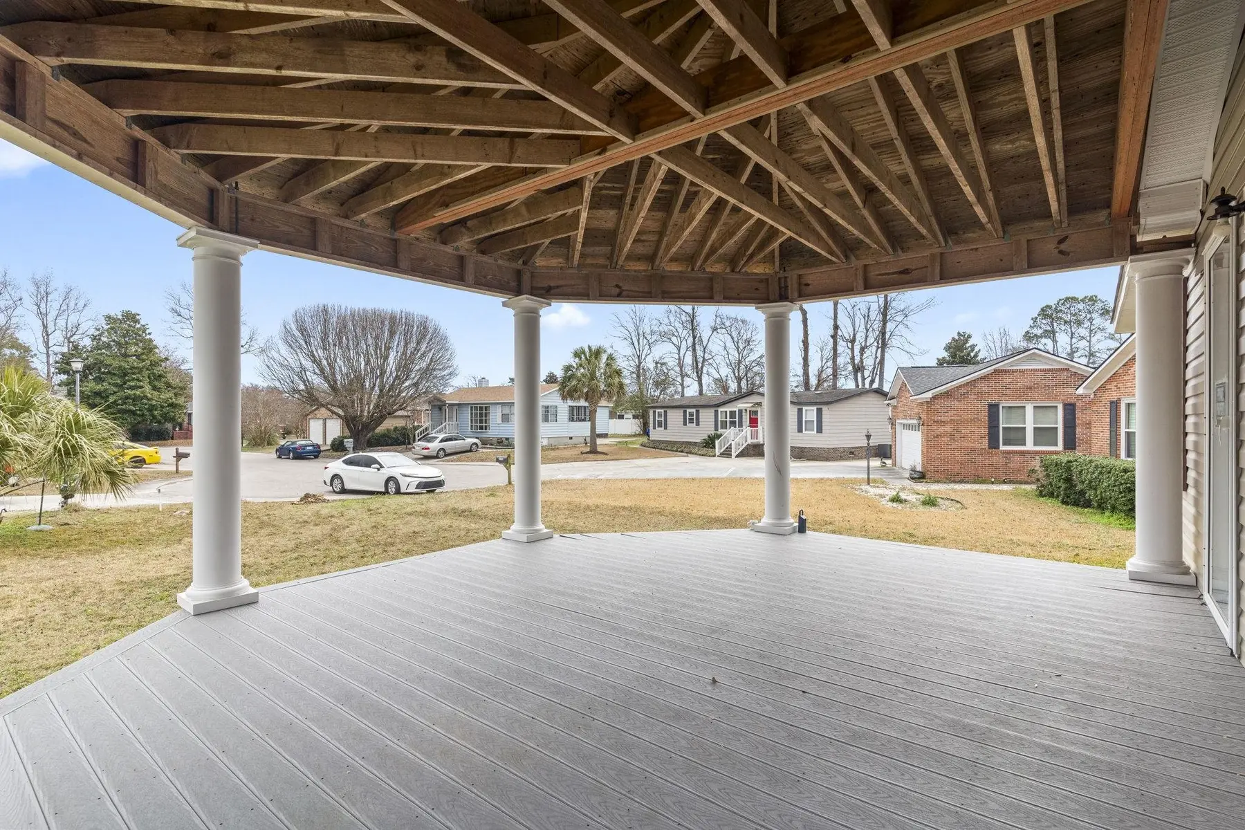 Covered front porch looking toward the street and neighboring homes