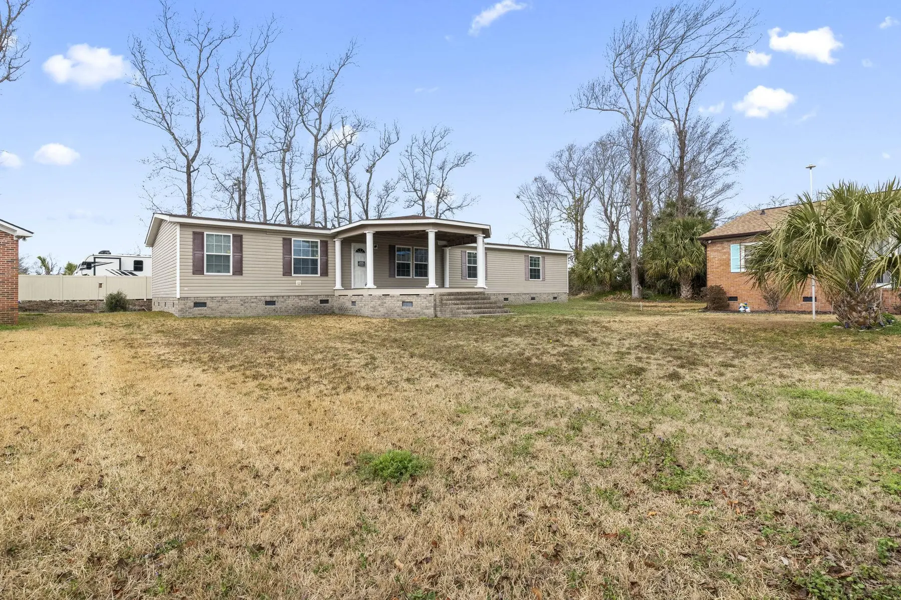 Wide front-yard view of the home and covered porch