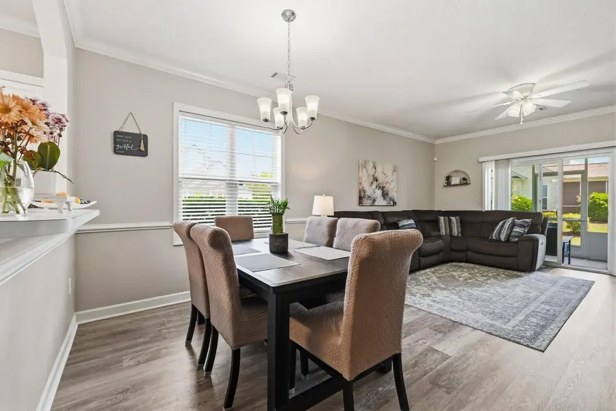 Open dining and living area with vinyl plank flooring