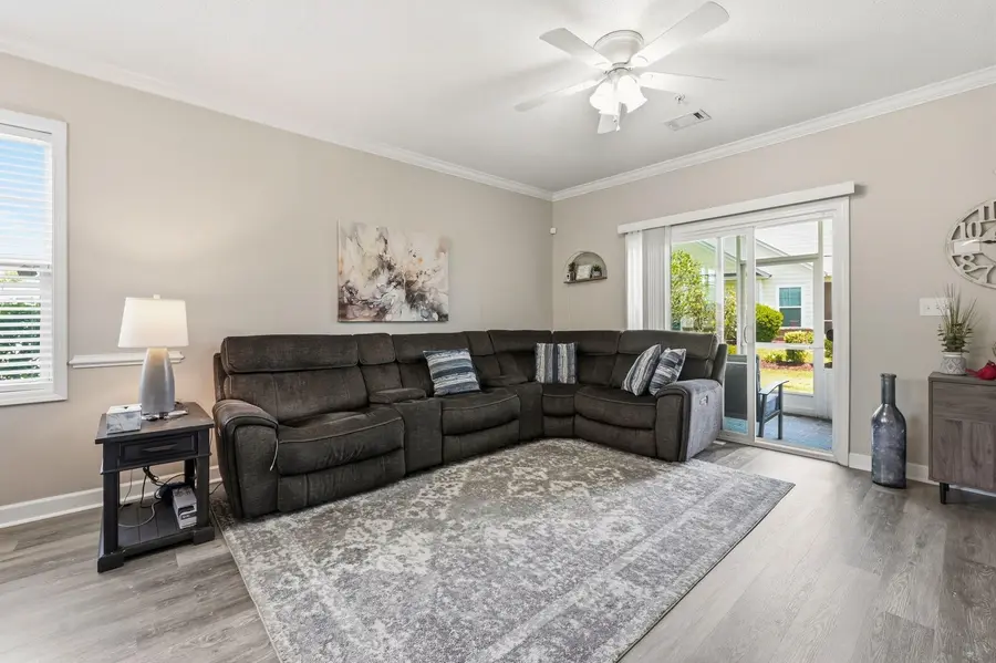 Living room with ceiling fan and screened-porch doors