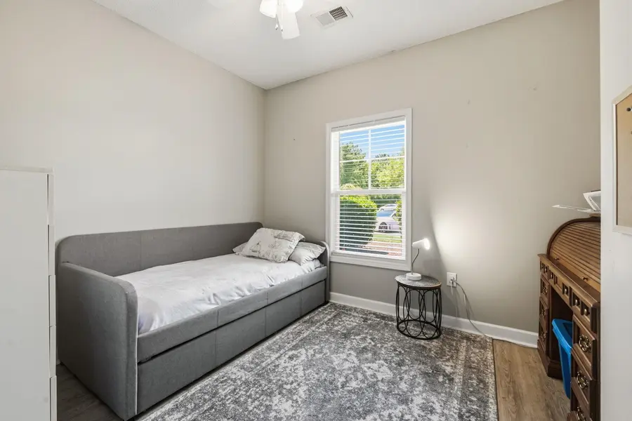 Second bedroom with window and ceiling fan