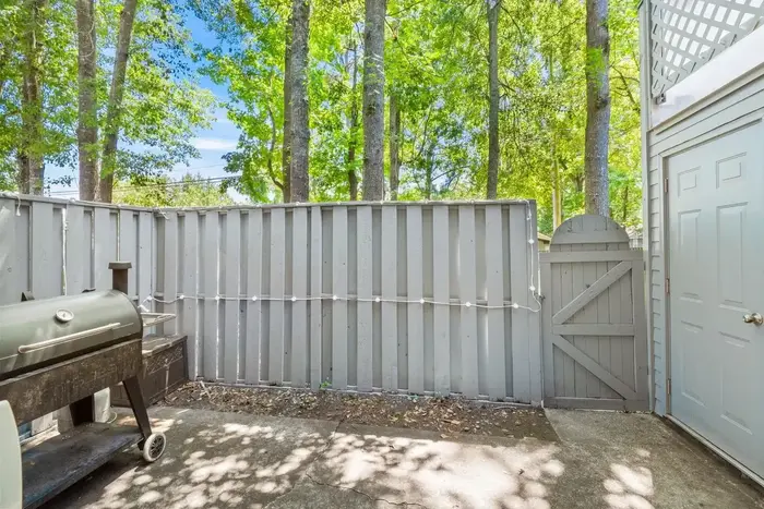 Fenced rear patio with attached outdoor storage