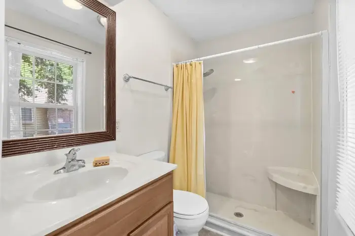 Primary bathroom with vanity, toilet and shower