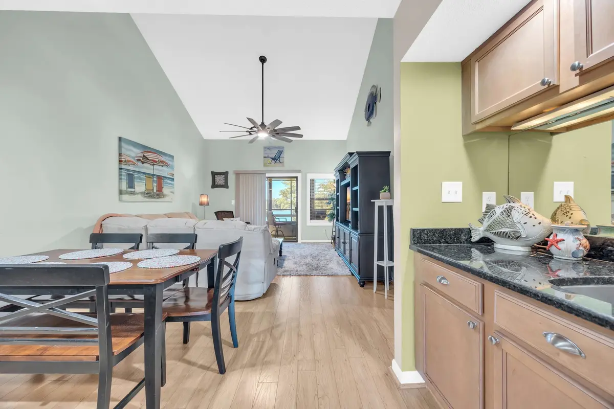 Kitchen and breakfast bar opening toward the dining and living areas