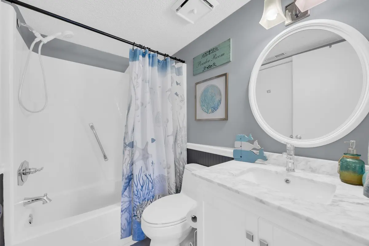 Full bathroom with vanity, toilet, and tub-shower combination