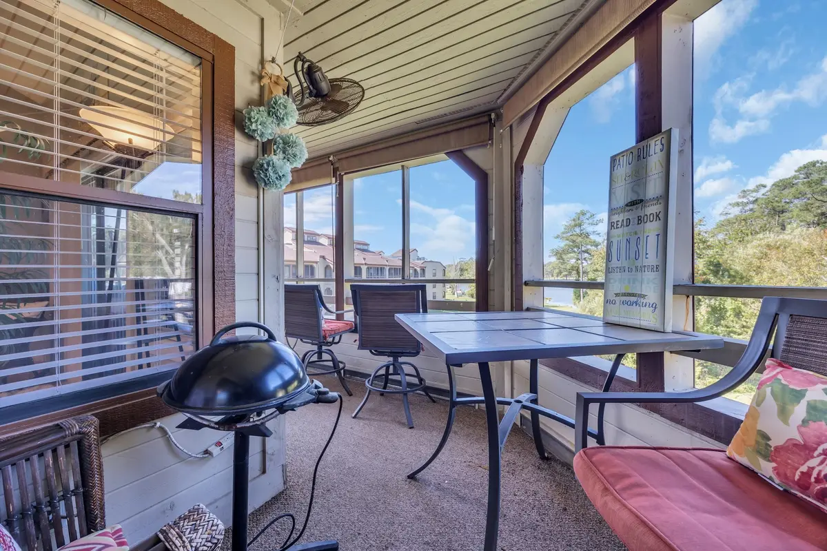 Screened porch furnished with seating and a dining table