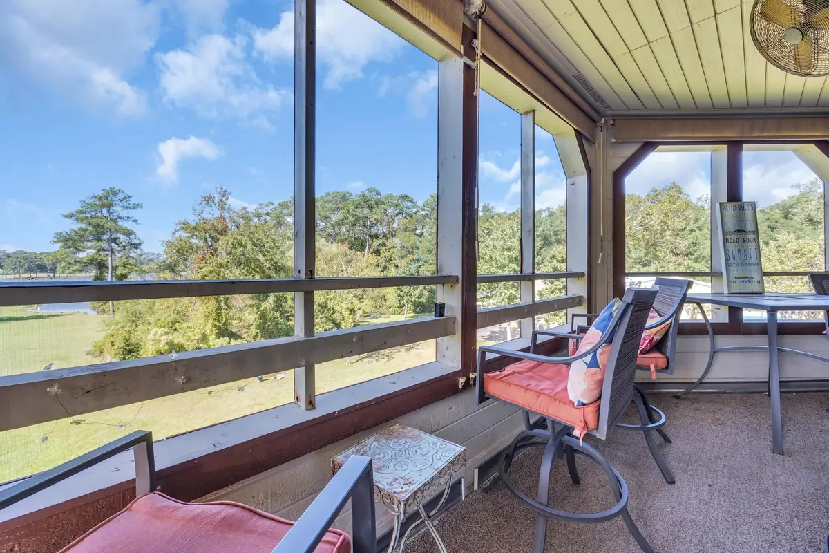Screened porch overlooking the lawn and pond