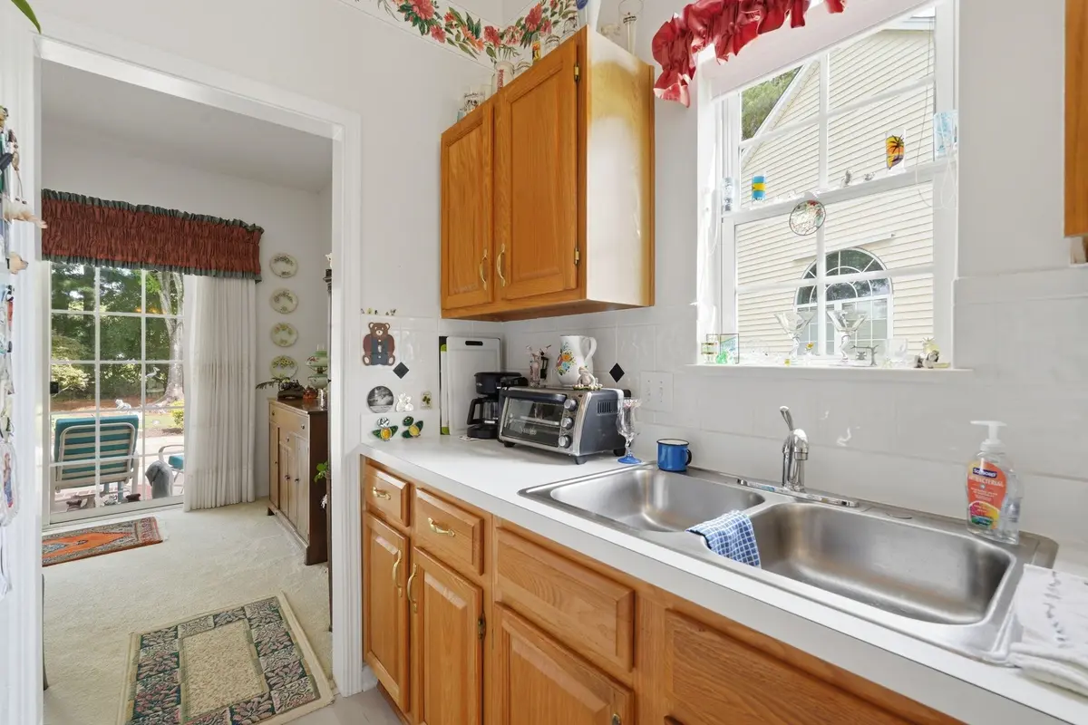Kitchen sink and wood cabinetry beside the breakfast nook