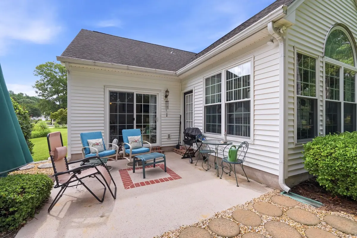 Concrete rear patio with outdoor seating