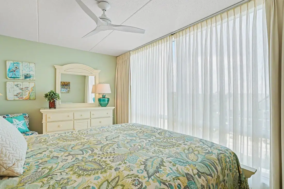 Second bedroom furnished with two beds and plantation shutters