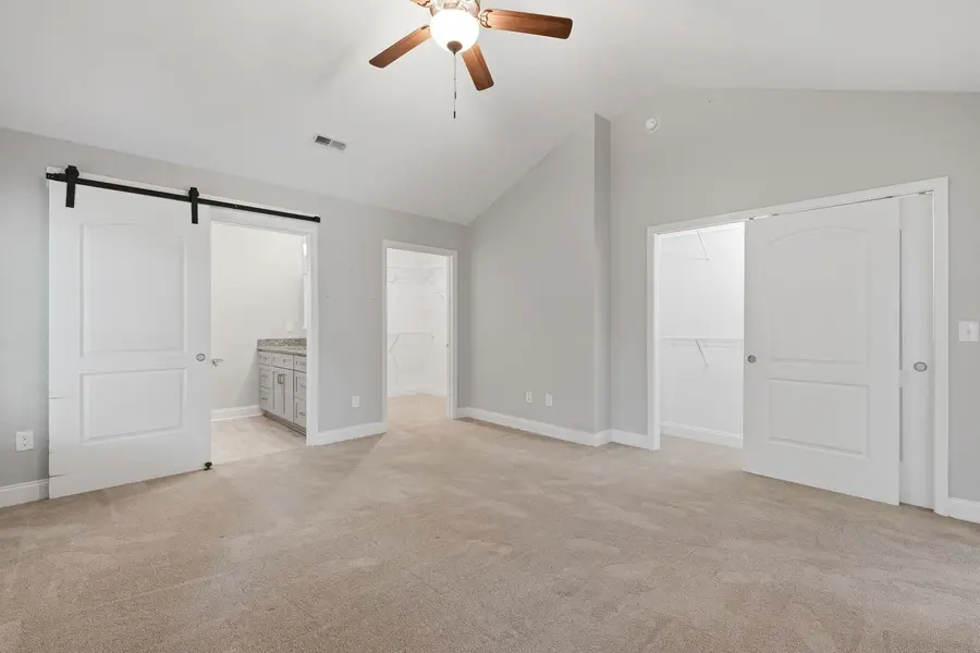 Primary bathroom vanity and barn-style door