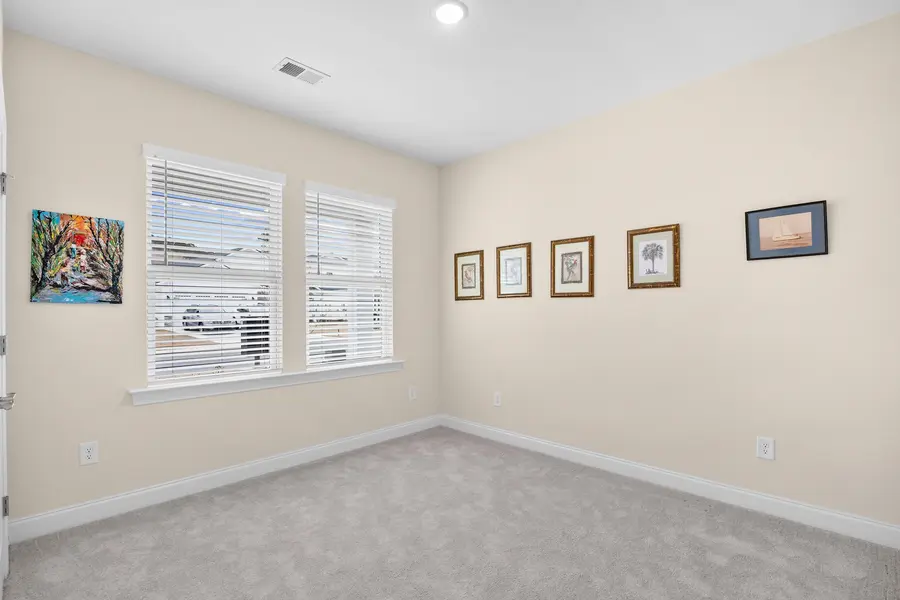 First-floor guest bedroom with two windows
