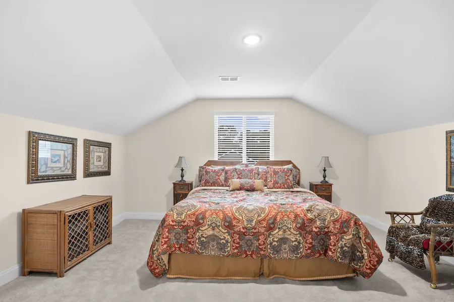 Upstairs guest suite with vaulted ceiling